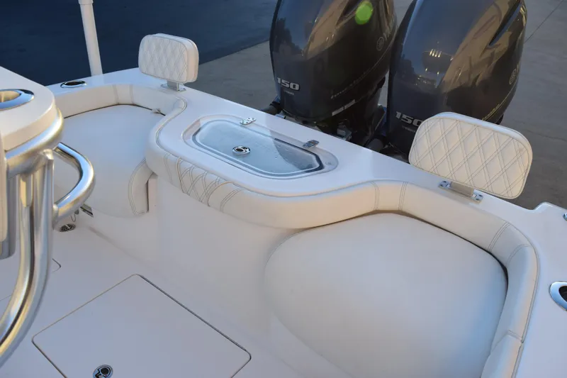 Slide: The Image of 2023 Contender 24 Sport boat interior with dual engines and cushioned seating. - 12
