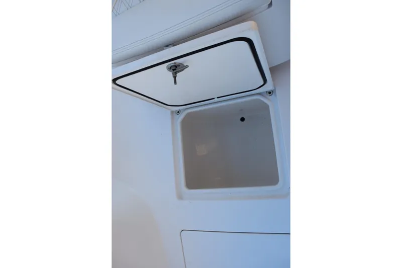 Slide: The Image of Open storage compartment on 2023 Contender 24 Sport boat. - 18