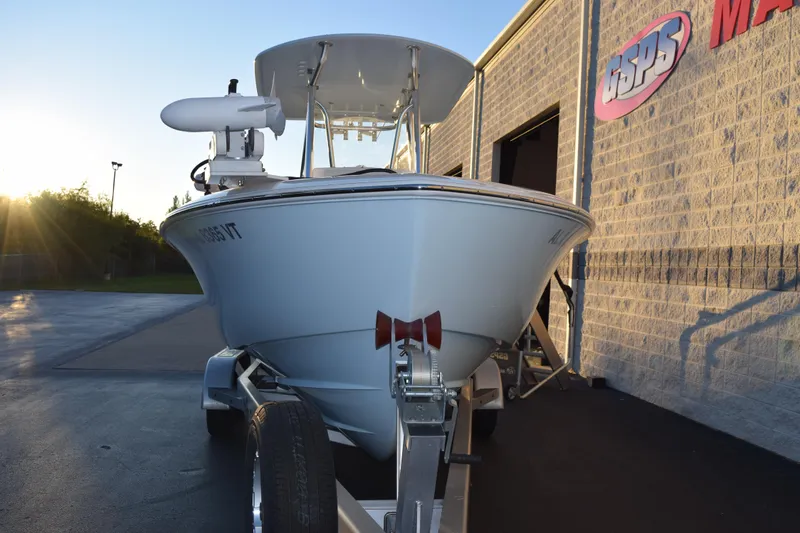 Slide: The Image of 2023 Contender 24 Sport boat on trailer at sunset near GSPS Marine building. - 3