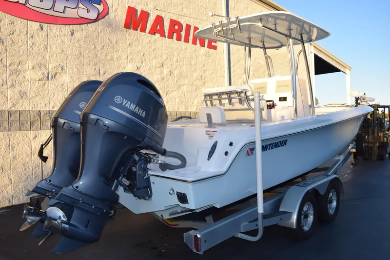 Slide: The Image of 2023 Contender 24 Sport boat with dual Yamaha engines on a trailer. - 4