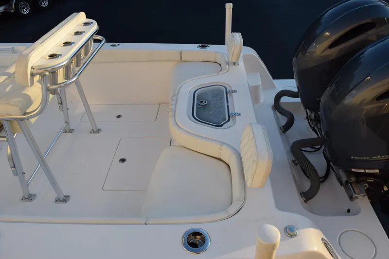 Slide: The Image of 2023 Contender 24 Sport boat deck with seating and dual outboard engines. - 8