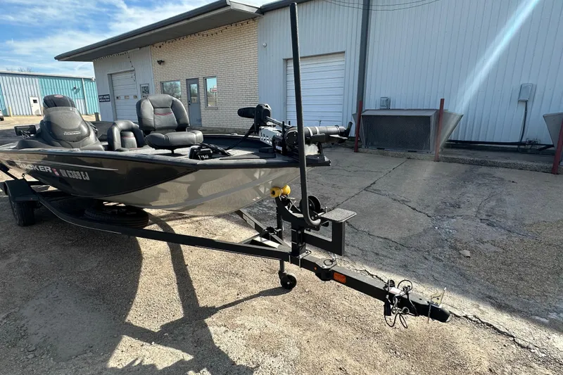Slide: The Image of 2023 Tracker Pro Team 190 TX boat on trailer outside industrial building. - 3