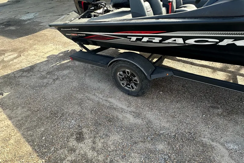 Slide: The Image of 2023 Tracker Pro Team 190 TX boat on trailer, parked on gravel surface. - 5