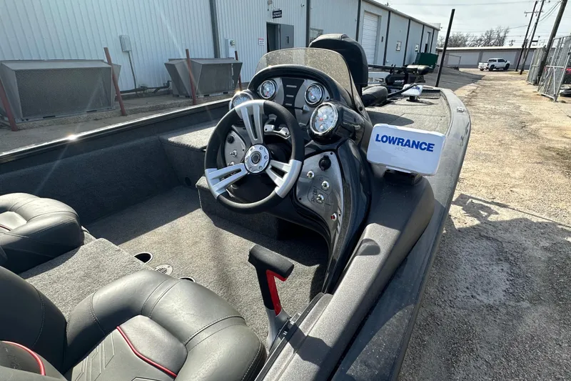 Slide: The Image of 2023 Tracker Pro Team 190 TX boat interior with steering wheel and Lowrance device. - 9