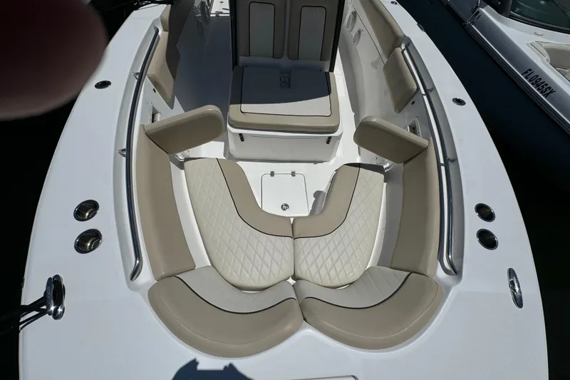 Slide: The Image of 2017 Sea Fox 288 Commander boat interior with beige cushioned seating and stainless steel fixtures. - 18