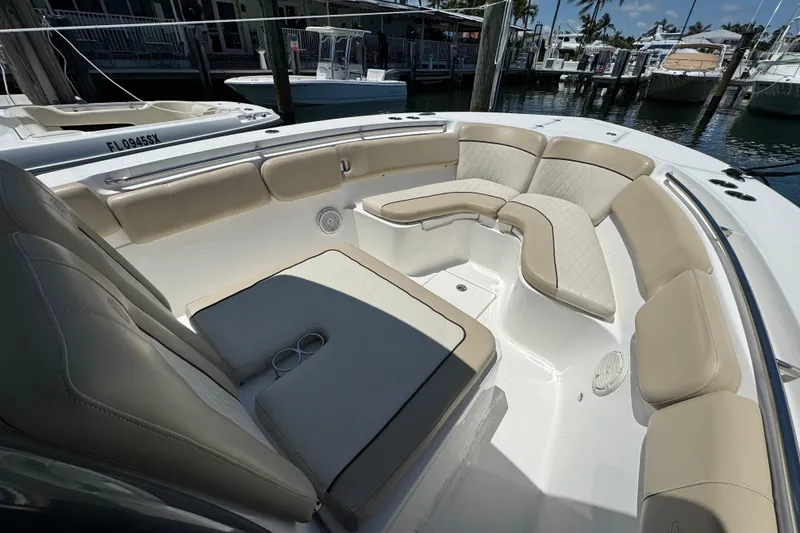 Slide: The Image of 2017 Sea Fox 288 Commander boat with spacious seating and elegant design at a marina. - 19