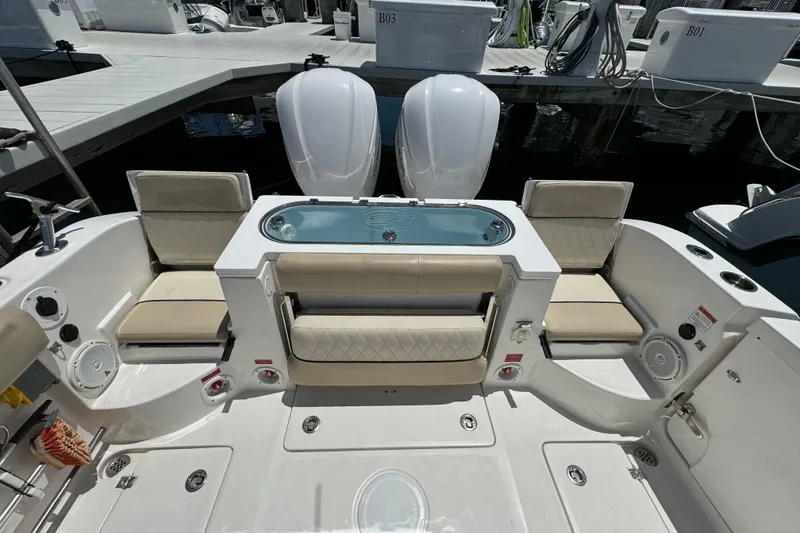 Slide: The Image of 2017 Sea Fox 288 Commander boat interior with seating and dual engines at a marina. - 27