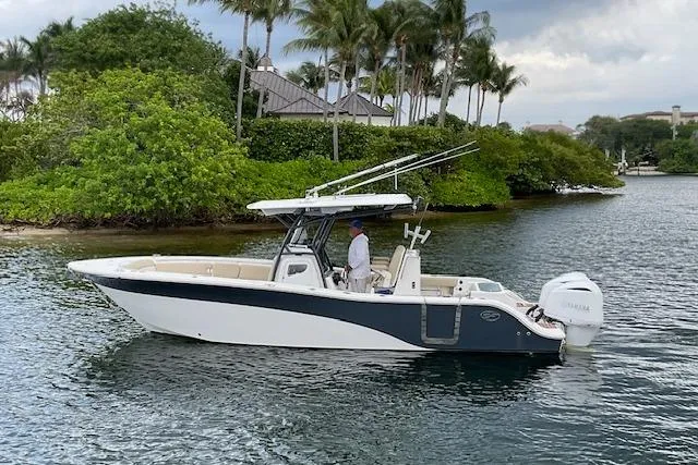 Slide: The Image of 2017 Sea Fox 288 Commander boat cruising near lush tropical shoreline. - 3