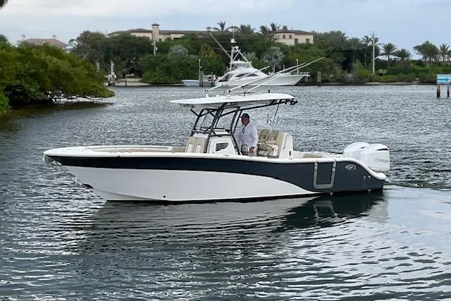 Slide: The Image of 2017 Sea Fox 288 Commander boat cruising on calm water near lush shoreline. - 4