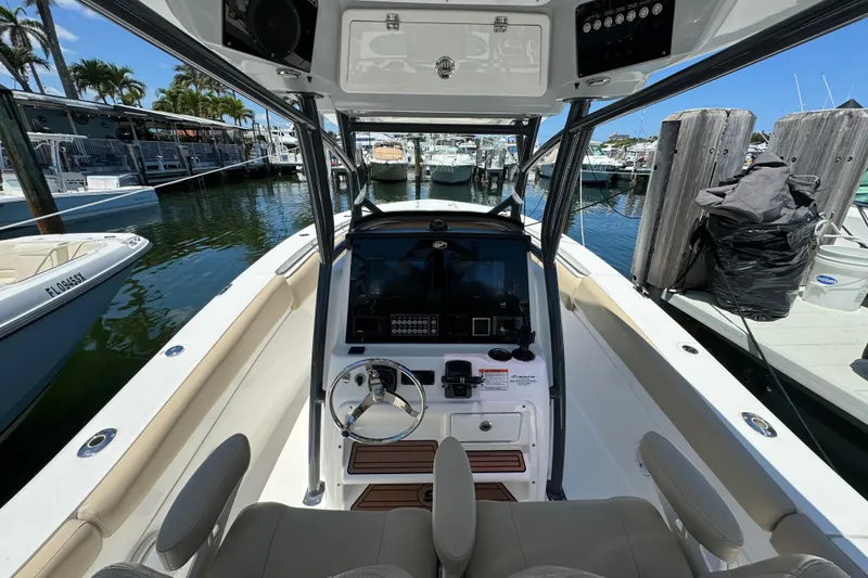 Slide: The Image of 2017 Sea Fox 288 Commander boat interior at marina, featuring helm and seating. - 5