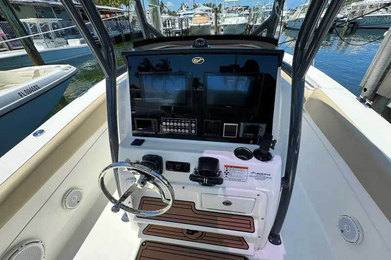 Slide: The Image of 2017 Sea Fox 288 Commander boat dashboard with steering wheel and navigation controls. - 6