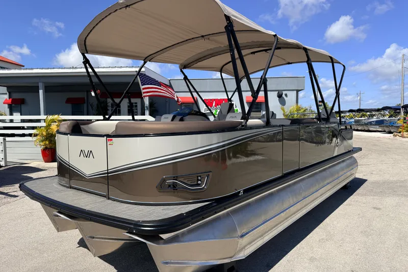 The Image of 2026 Avalon 2385 LSZ Rear Fish Tri Toon boat with canopy, parked outdoors. - 1