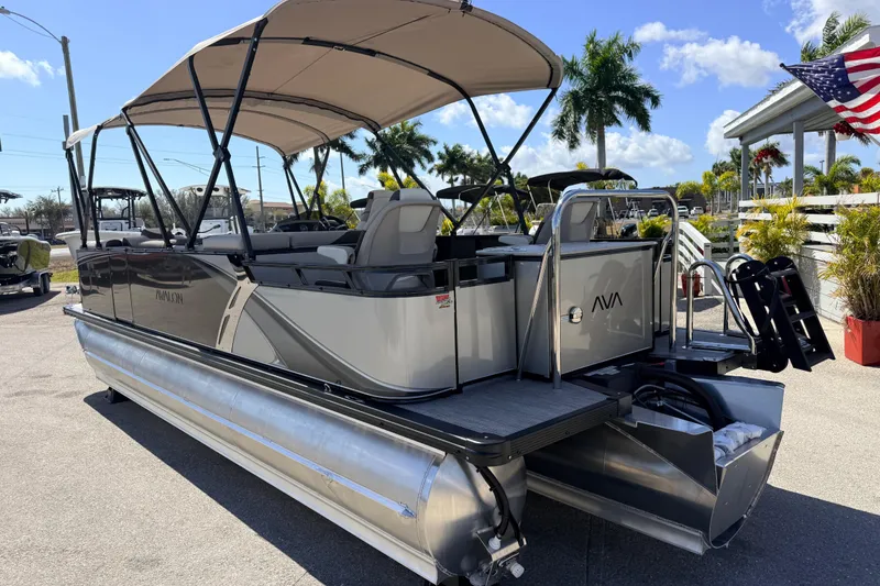 Slide: The Image of 2026 Avalon 2385 LSZ Rear Fish Tri Toon boat with canopy, parked outdoors. - 10