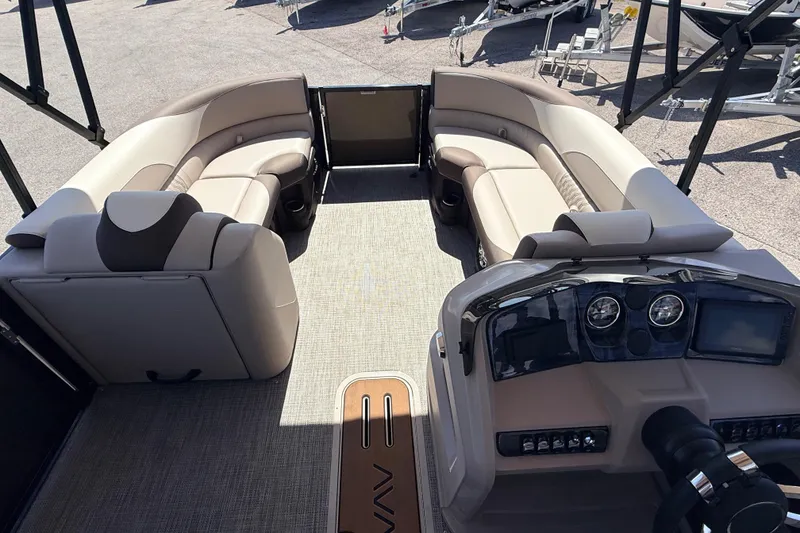 Slide: The Image of 2026 Avalon 2385 LSZ Tri Toon boat interior with plush seating and modern dashboard. - 13