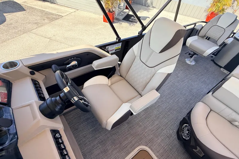 Slide: The Image of 2026 Avalon 2385 LSZ Tri Toon boat interior with luxurious seating and modern steering console. - 17