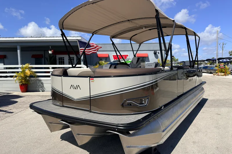 Slide: The Image of 2026 Avalon 2385 LSZ Rear Fish Tri Toon boat with canopy, parked outdoors. - 2