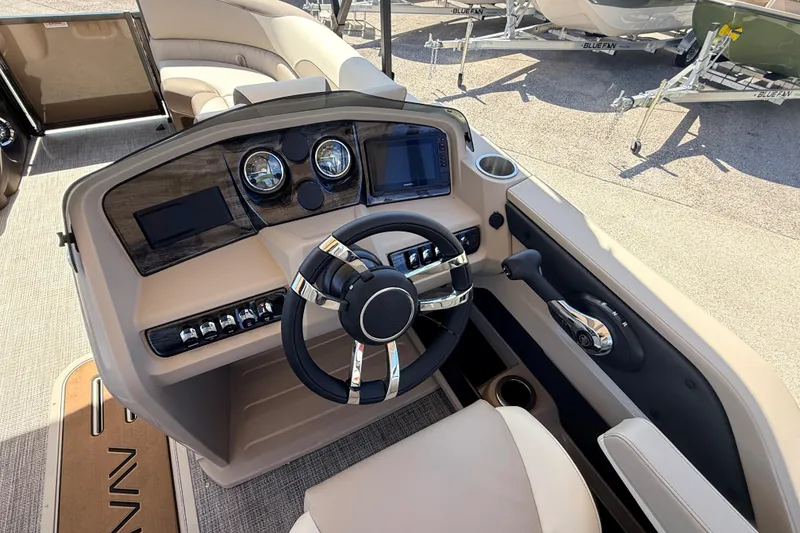 Slide: The Image of 2026 Avalon 2385 LSZ Tri Toon boat dashboard with modern controls and steering wheel. - 23