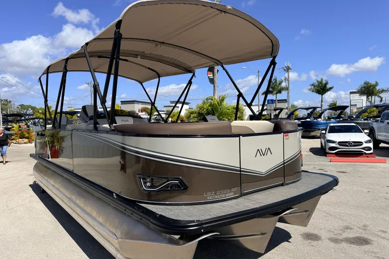 Slide: The Image of 2026 Avalon 2385 LSZ Rear Fish Tri Toon boat with canopy in a sunny outdoor setting. - 5