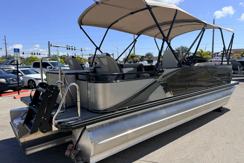 Slide: The Image of 2026 Avalon 2385 LSZ Rear Fish Tri Toon boat with canopy in parking lot. - 6