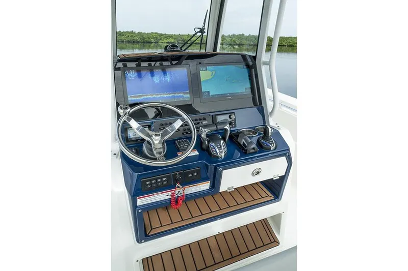 Slide: The Image of Manufacturer Provided Image: 2025 Cobia 285 Center Console helm with dual screens and controls. - 12