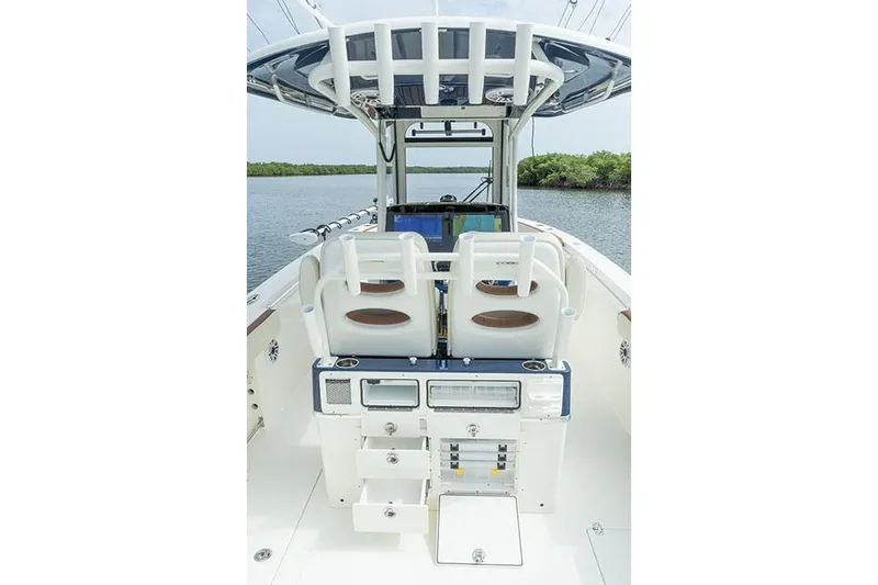 Slide: The Image of Manufacturer Provided Image: 2025 Cobia 285 Center Console boat interior with dual seats and control panel. - 13
