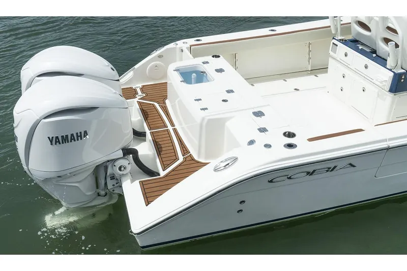 Slide: The Image of Manufacturer Provided Image: 2025 Cobia 285 Center Console boat with Yamaha engines on water. - 14