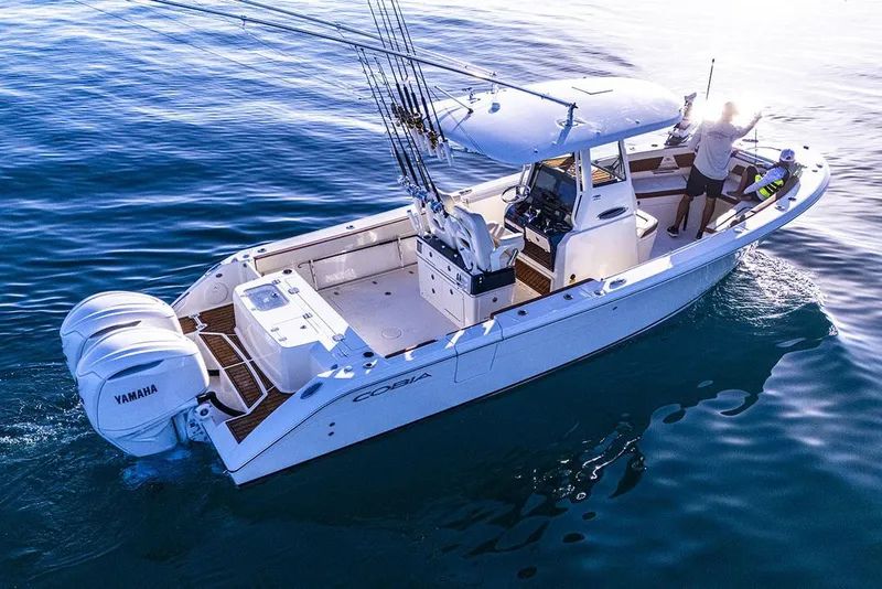 Slide: The Image of Manufacturer Provided Image: 2025 Cobia 285 Center Console boat on calm blue water. - 4
