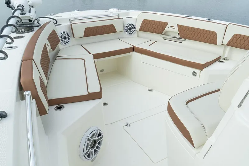 Slide: The Image of Manufacturer Provided Image: 2025 Cobia 285 Center Console boat interior with cushioned seating and speakers. - 6