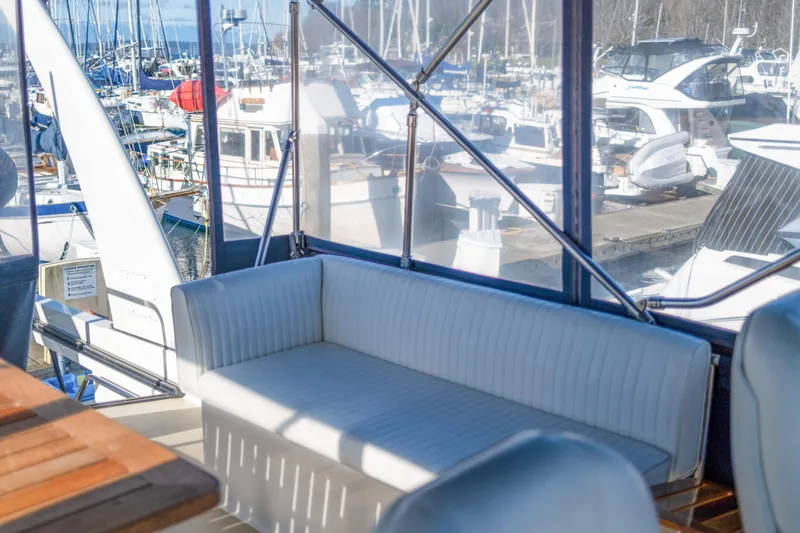 Slide: The Image of Coastal Craft 45 yacht interior, 2013 model, with marina view and white seating. - 11