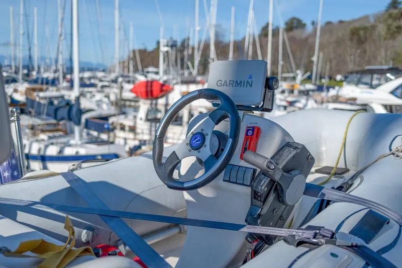 Slide: The Image of Steering wheel and Garmin GPS on a 2013 Coastal Craft 45 boat in a marina. - 18