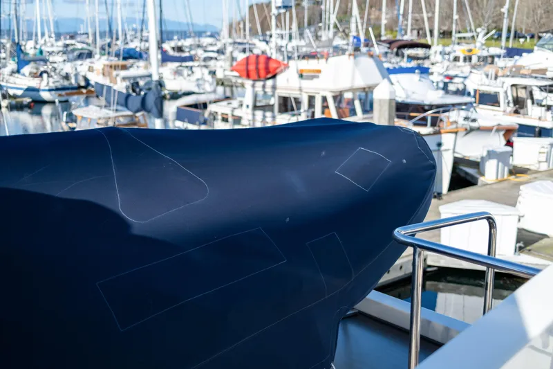 Slide: The Image of 2013 Coastal Craft 45 yacht covered at marina, surrounded by various boats. - 19