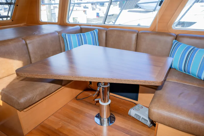 Slide: The Image of Luxurious interior of 2013 Coastal Craft 45 yacht with wooden table and leather seating. - 23