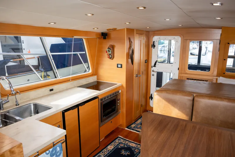 Slide: The Image of Luxurious interior of 2013 Coastal Craft 45 yacht with modern kitchen and seating area. - 25
