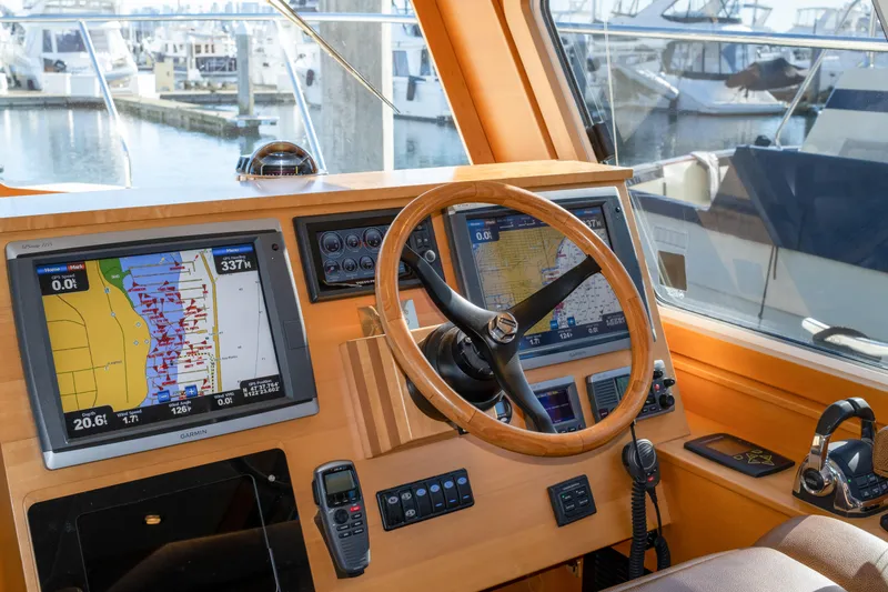 Slide: The Image of Pilothouse of 2013 Coastal Craft 45 yacht with navigation screens and steering wheel. - 27