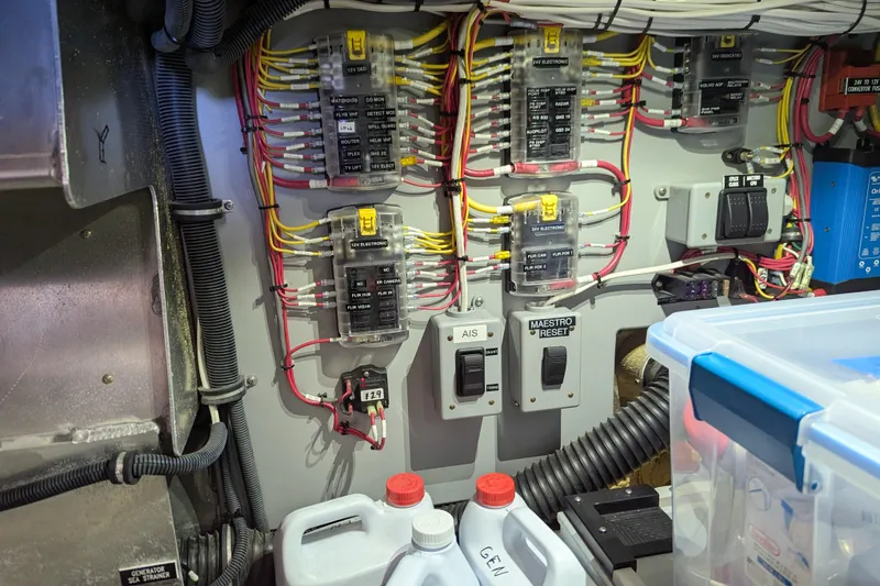 Slide: The Image of Electrical panel of a 2013 Coastal Craft 45 boat, featuring wiring and switches. - 45