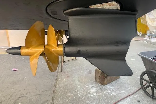 Slide: The Image of Propeller and rudder of a 2013 Coastal Craft 45 boat, displayed in a workshop. - 48