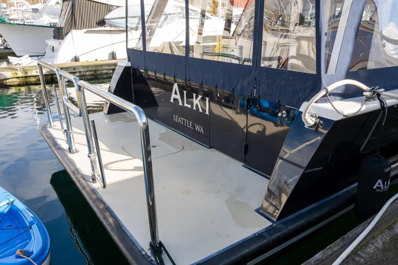 Slide: The Image of 2013 Coastal Craft 45 yacht docked, featuring sleek design and Seattle, WA registration. - 5