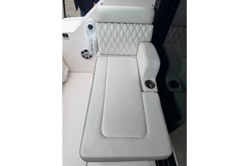 Slide: The Image of Luxurious white seating on 2021 Regal 36 XO boat with cup holder and speaker. - 10