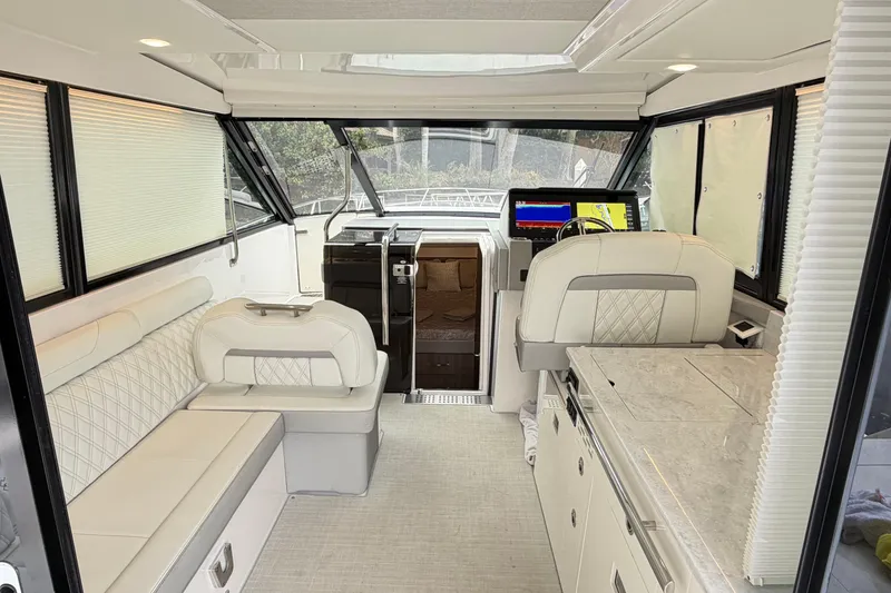 Slide: The Image of 2021 Regal 36 XO yacht interior with luxurious seating and modern navigation system. - 16