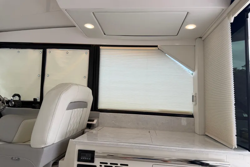 Slide: The Image of Interior of 2021 Regal 36 XO yacht with modern seating and window blinds. - 17