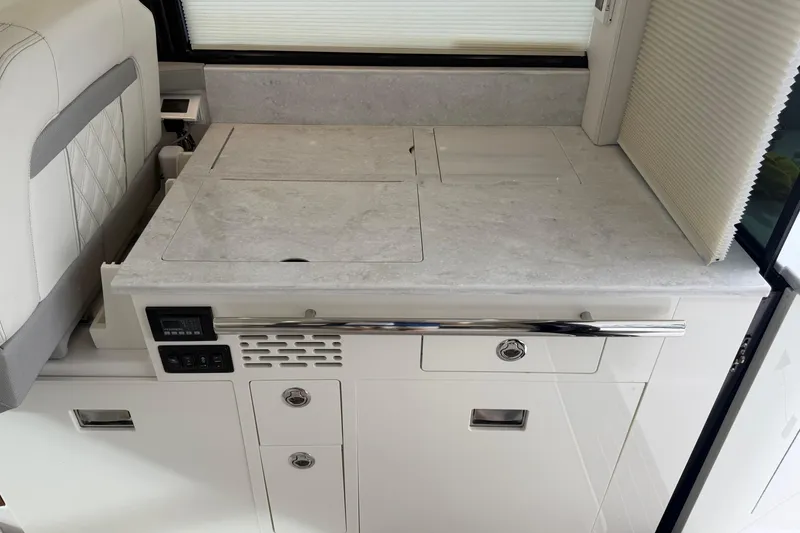 Slide: The Image of 2021 Regal 36 XO yacht interior with sleek countertop and modern cabinetry. - 18