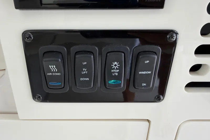 Slide: The Image of Control panel of a 2021 Regal 36 XO boat with air conditioning and lighting switches. - 22