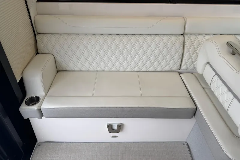 Slide: The Image of Luxurious seating on 2021 Regal 36 XO boat with diamond-stitched upholstery and cup holder. - 26