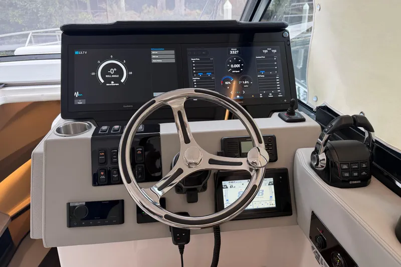 Slide: The Image of 2021 Regal 36 XO boat helm with advanced navigation displays and controls. - 30