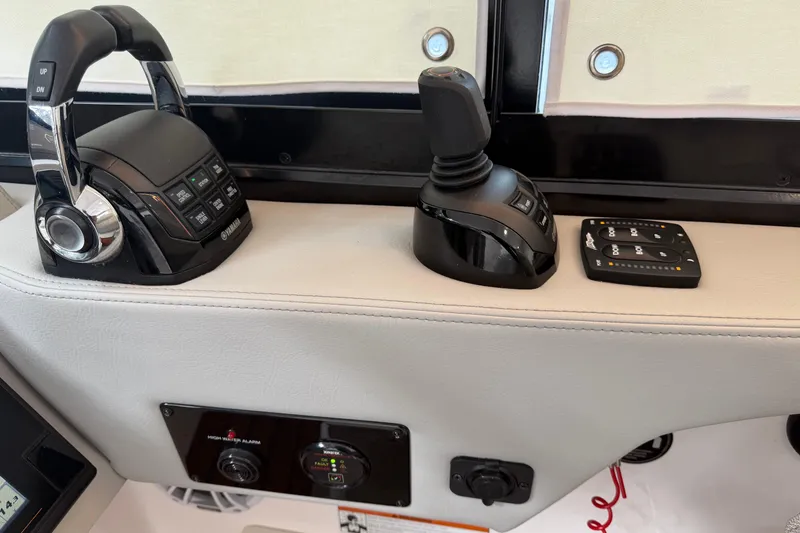 Slide: The Image of Control panel of a 2021 Regal 36 XO boat with Yamaha throttle and joystick. - 36