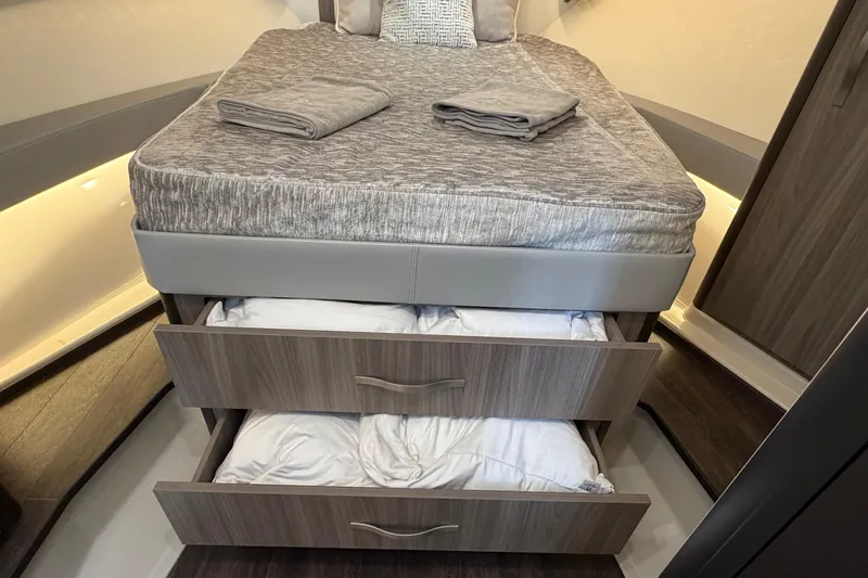 Slide: The Image of 2021 Regal 36 XO cabin with bed, storage drawers, and modern interior design. - 41