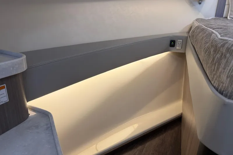 Slide: The Image of Interior view of 2021 Regal 36 XO boat with ambient lighting and modern design. - 43