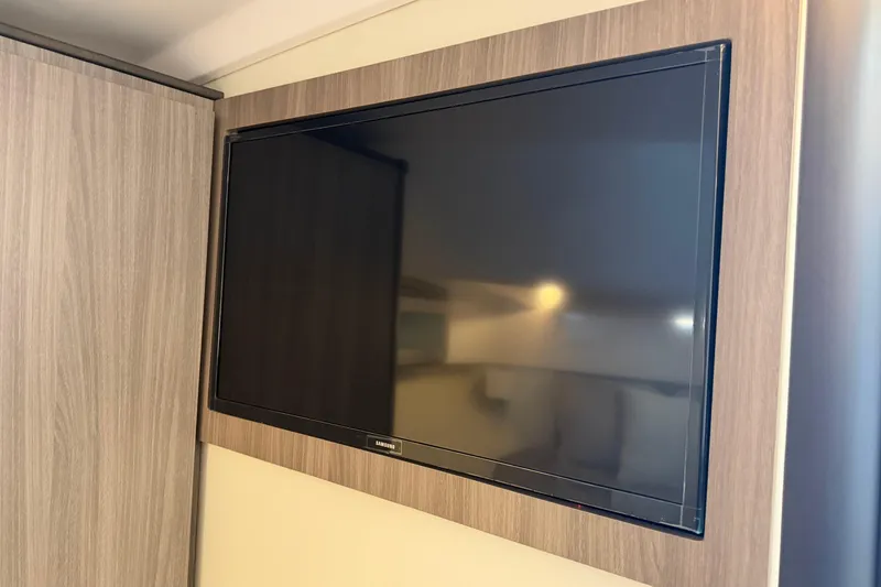 Slide: The Image of Wall-mounted Samsung TV in 2021 Regal 36 XO yacht interior. - 44