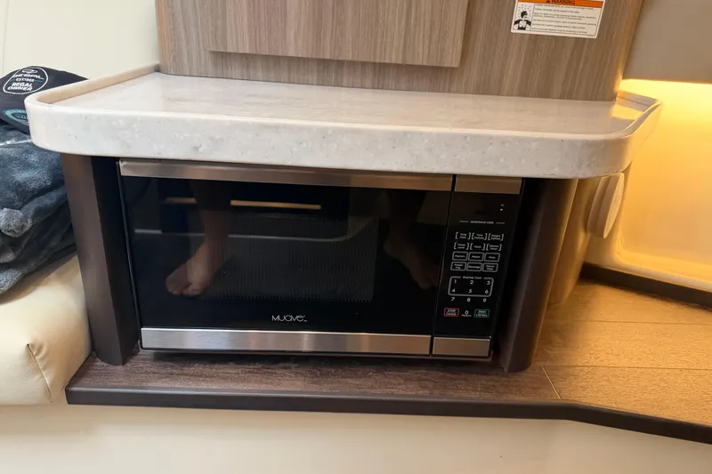 Slide: The Image of Microwave in 2021 Regal 36 XO yacht interior, under a sleek countertop. - 49
