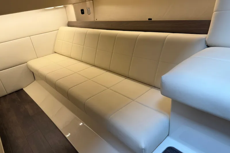 Slide: The Image of Luxurious interior seating of 2021 Regal 36 XO yacht with cream upholstery. - 51